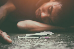 Drug addiction, male using drugs in syringe